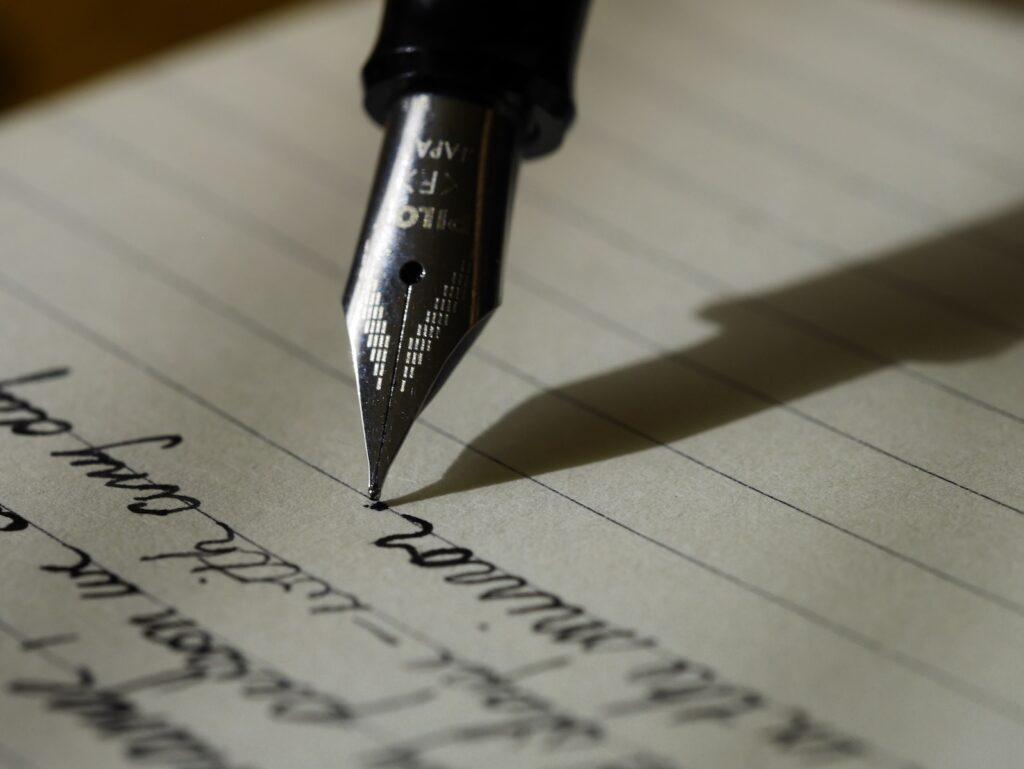 fountain pen on black lined paper handwritten letter